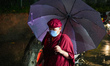 Buddhist devotees perform kora around the Swayambhunath during the Saga Dawa festival in K...