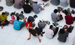 People gather for a communal iftar meal at Al-Azhar Mosque on the Day of Arafah in Cairo,...