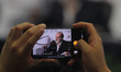 A person records with a cell phone during the press conference of businessman Carlos Slim...