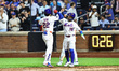New York Mets player Juan Soto #22 is congratulated at home plate by Bo Bichette #19 after...