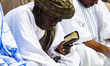 A man reads the Quran as Nigerian Muslim faithful pray to celebrate the 2026 Eid-el-Kabir...