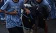 Residents parade goats during a traditional livestock parade in the city streets before th...