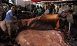Traders at the city's main wholesale center, Atura Depot, dry the hides of cattle recently...