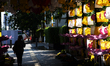 Pedestrians walk on a sidewalk in Jakarta's central business district during a quiet rush...