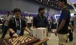 A child plays chess with the AI-powered chessboard 'Mico' during the opening day of Mumbai...