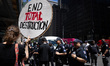 Members of the New York Police Department (NYPD) arrest climate activists from a coalition...