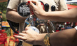 A person serves beer to customers during a hot day in Lisbon, Portugal, on May 30, 2026. A...