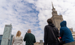 Spectators watch from the streets below as Estonian slackliner Jaan Roose crosses a highli...