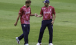 David Willey of Northamptonshire County Cricket Club (left) is handed the ball by fellow b...