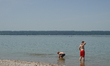 Two boys play in the shallow water at Lake Ammersee in Herrsching am Ammersee, Upper Bavar...