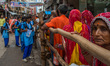 Kanwariya waits at queue at Kashi Vishwanath Temple after fill his pots with holy water fr...