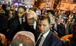 Tunisian President Kais Saied meets local residents as he walks through the streets during...