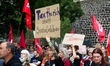 Nearly a hundred people participate in a demonstration against the federal government's pl...