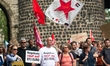 Nearly a hundred people participate in a demonstration against the federal government's pl...