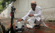 Pedestrians collect water from roadside WASA supply lines in Dhaka, Bangladesh, on June 2,...