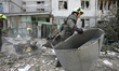 Rescuers from the State Emergency Service remove rubble outside a nine-storey apartment bl...