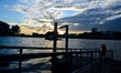 A man watch the sunset under one of the bridges above the The Chao Phraya river in Bangkok...