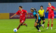 Singapore women's national football team player Yasmine Binte Zaharin (right) attempts to...