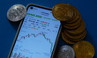 A smartphone displays the sharp decline of Bitcoin in Yichang City, Hubei Province, China,...