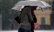 Two young girls walk in heavy rain in the city center of Bonn, Germany, on June 4, 2026. 