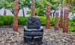 A large stone tiki statue carved from volcanic rock in Motu Tautau, French Polynesia, on M...