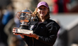 Mirra Andreeva celebrates with the winner's trophy after winning her final women's singles...