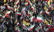 Pro-government supporters wave Iranian national flags as they participate in the 97th nigh...