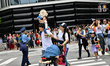 A family participates in the Tokyo Pride 2026 Parade, with a child riding on a parent's sh...