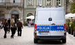 A marked police van is seen among pedestrians and tourists on Main Market Square in Krakow...