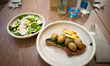 A pork steak with white asparagus, potatoes, and salad is served in the restaurant at Novo...
