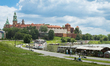 A wide view from Czerwienski Boulevard shows a bend of the Vistula River, riverside restau...