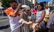Catholic pilgrims gather along the streets surrounding Plaza de Cibeles during the Corpus...