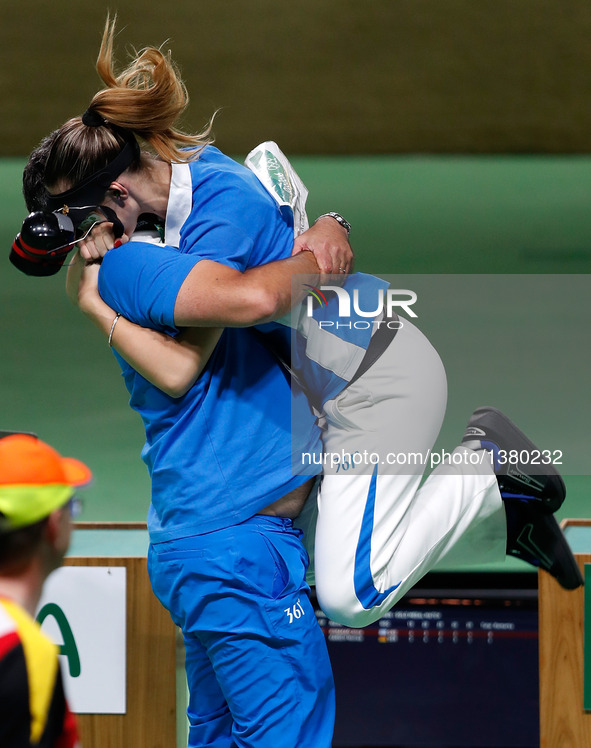 Anna Korakaki (R) of Greece hugs with her coach, also her father after the women's 25m pistol final of shooting at the 2016 Rio Olympic Game...