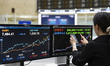 A Korea Exchange (KRX) employee checks the closing stock prices of Samsung Electronics and...