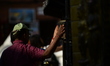 Nepalese devotees rotate a Buddhist prayer wheel at Swayambhu Mahachaitya in Kathmandu, Ne...