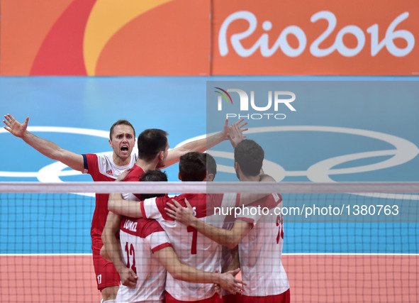 Poland 's Pawel Zatorski (1st, L) celebrates with his teammates for scoring against Iran during a men's preliminary match of volleyball at t...