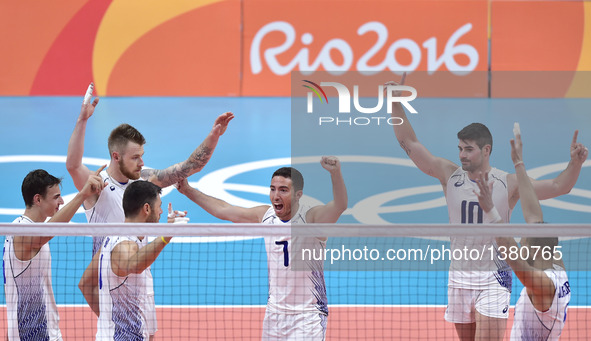Players of Italy celebrate after scoring against the United States of America during the men's volleyball preliminary match at the 2016 Rio...