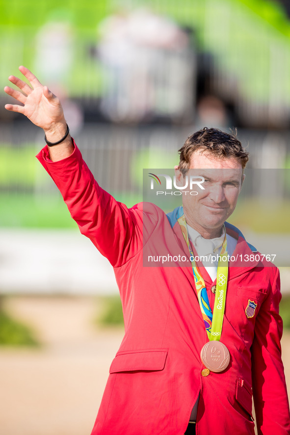 Phillip Dutton of the United States celebrates at the awarding ceremony of the equestrian eventing individual competition at the 2016 Rio Ol...