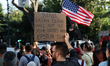 Environmental activists, families, and young people participate in a demonstration outside...