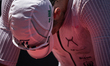 An athlete bows his head in exhaustion after crossing the finish line of IRONMAN 70.3 Algh...