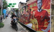 A lane is adorned with giant flex banners of Portugal football stars and national flags in...