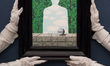 LONDON, UNITED KINGDOM - JUNE 10, 2026: Art handlers hold a painting by Rene Magritte “La...