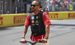 Lewis Hamilton of Great Britain and Scuderia Ferrari rides a scooter on the track before t...