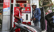 A gas station worker fills a motorbike with gasoline at a Pertamina gas station in Jakarta...
