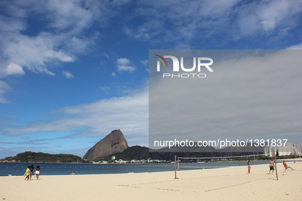 Rio de Janeiro, Brazil, 11 August 2016: Movement of swimmers and fans in Flamengo Beach on the south side of Rio de Janeiro. With the sailin...