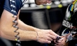 A mechanic performs precision work on the car of Formula 1 driver George Russell of the Me...