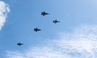 Two fifth-generation F-35A Lightning II jets, escorted by two Polish Air Force F-16 fighte...