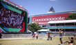 A woman dances as the Qatar vs Switzerland build-up is shown on the big screen at the FIFA...