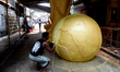 Workers craft a replica of the FIFA World Cup trophy at a workshop in Kolkata, India, on J...