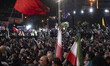 Pro-government supporters holding Iranian national flags participate in a nightly rally ma...